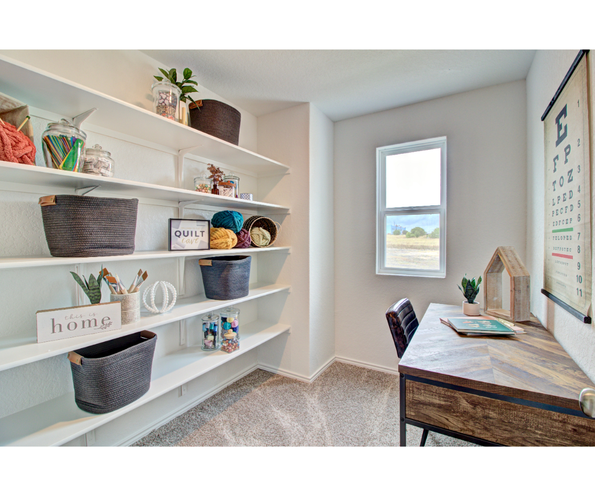 A room with a table and shelves.