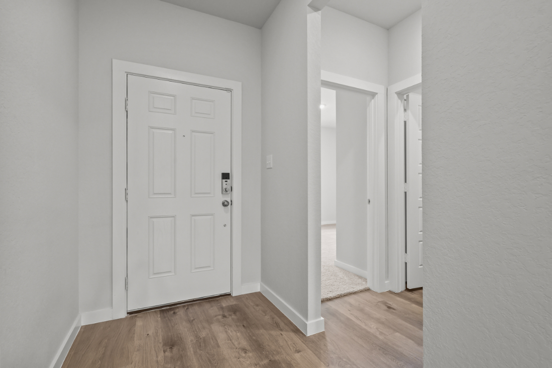 A hallway with white doors.