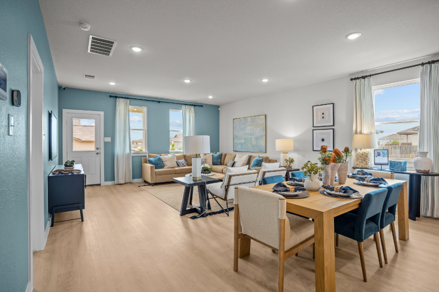 A large living room with a dining table and chairs.