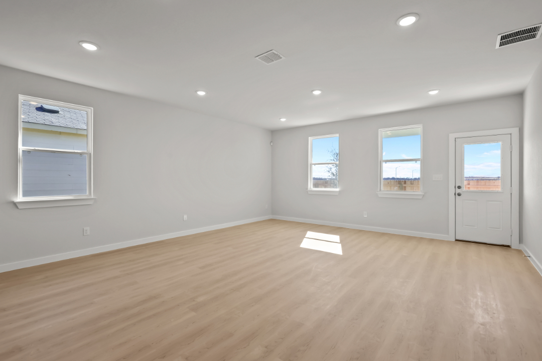 A room with a wood floor and white doors.