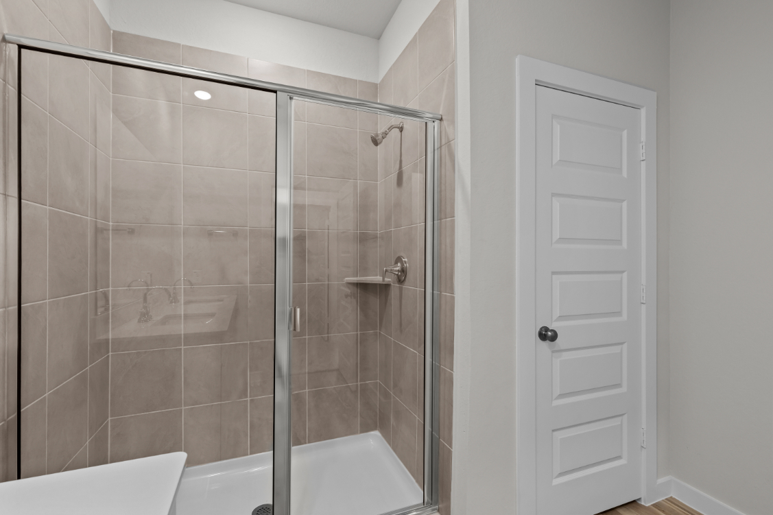 A shower with a glass door.