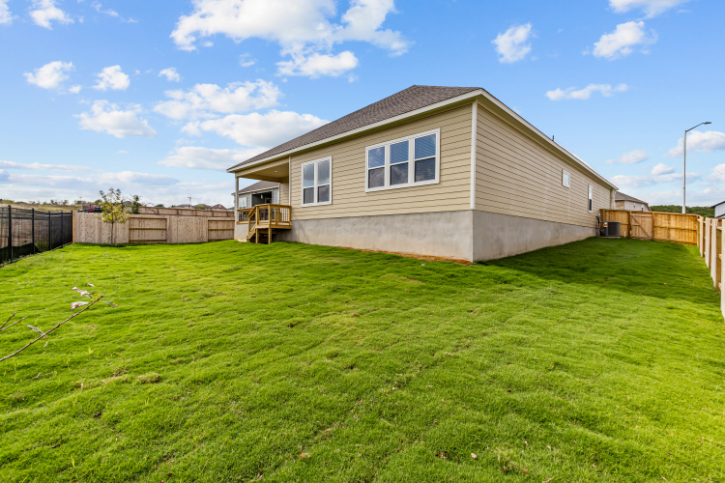 A house with a fence and grass.