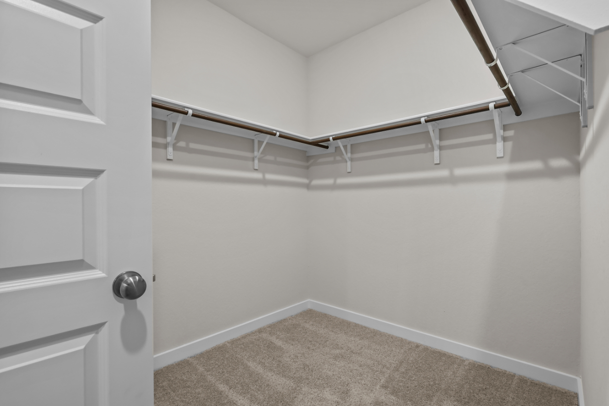 A white staircase with a rug.