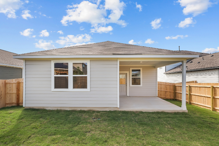 A house with a fence and grass.