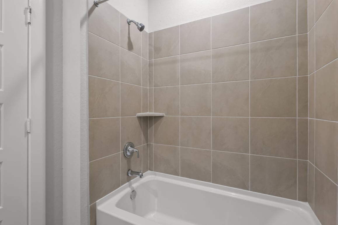 A bathtub in a bathroom.