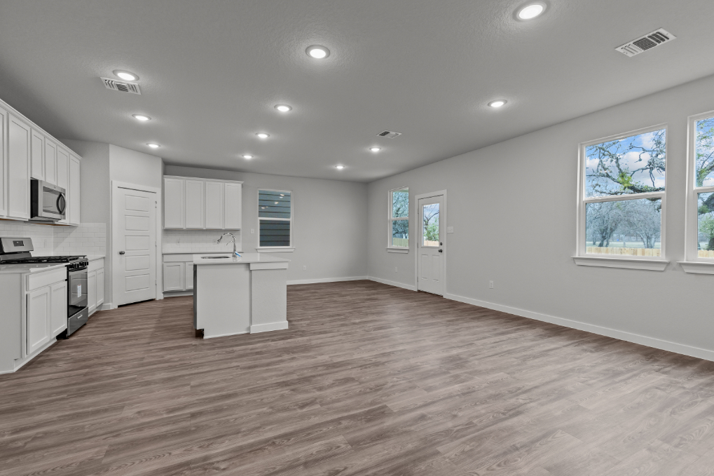 A kitchen with white cabinets.