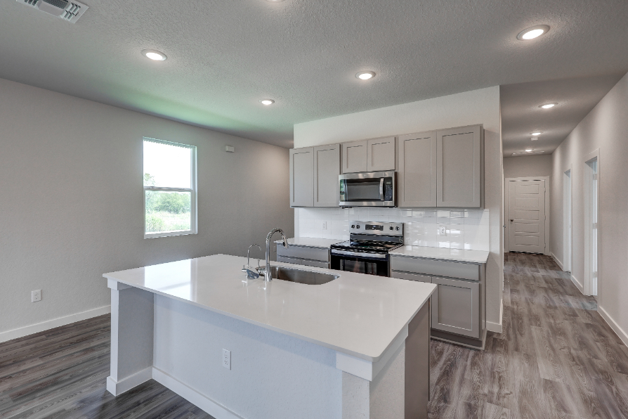A kitchen with white cabinets.