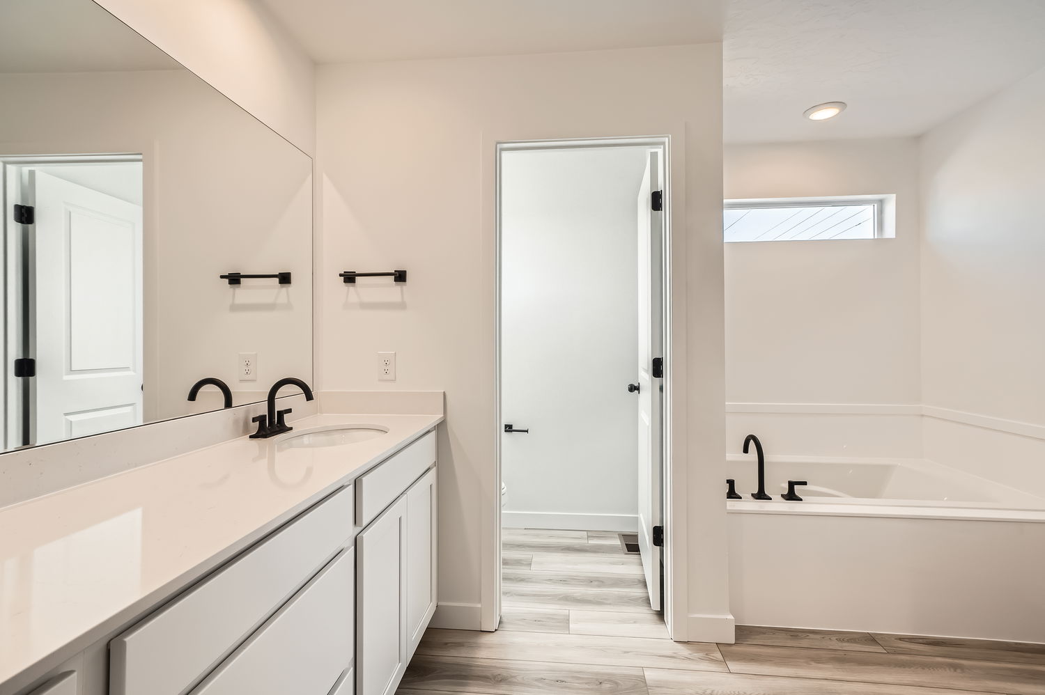 A bathroom with a tub sink and a bathtub.