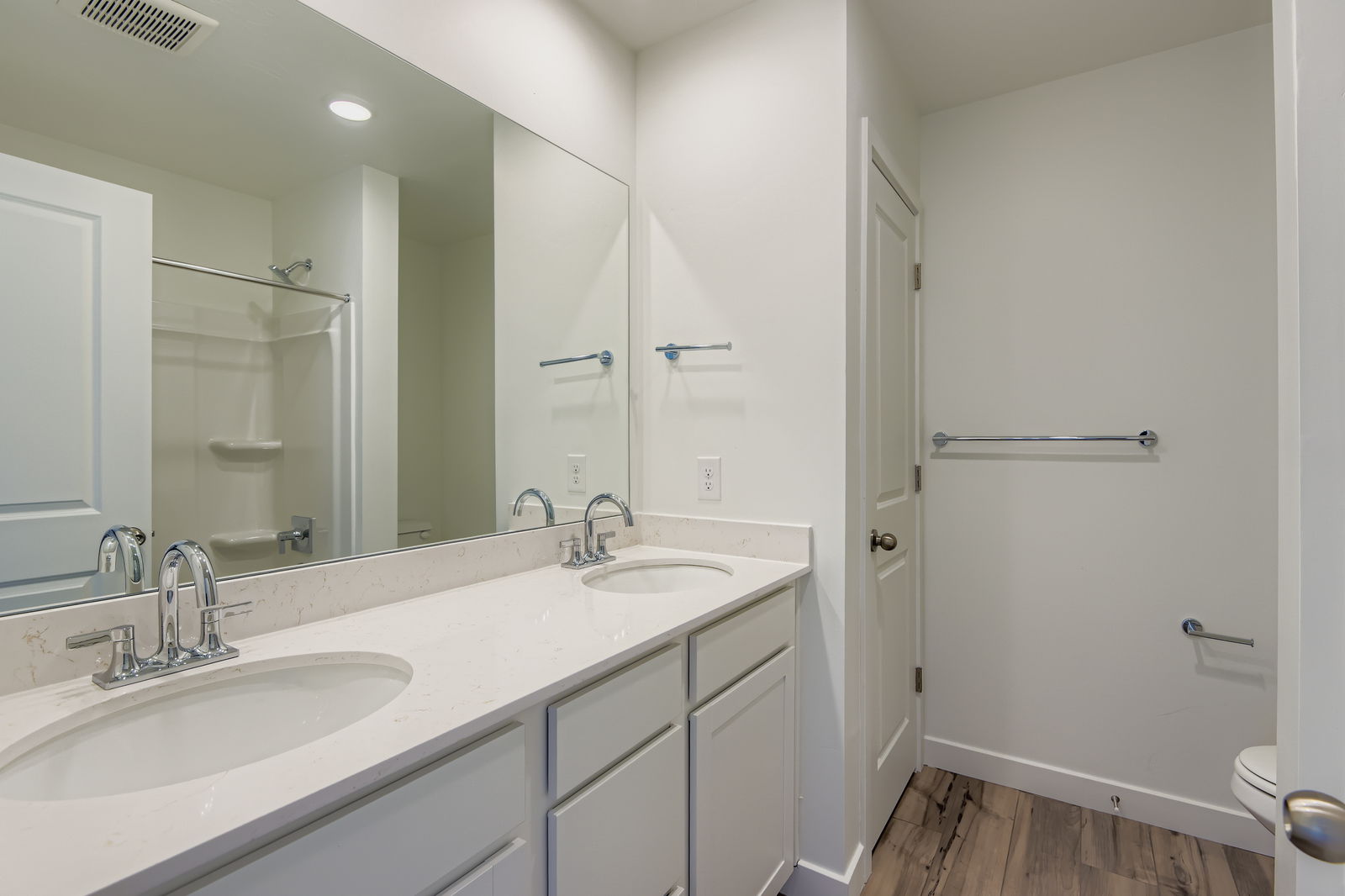 A bathroom with a large mirror.