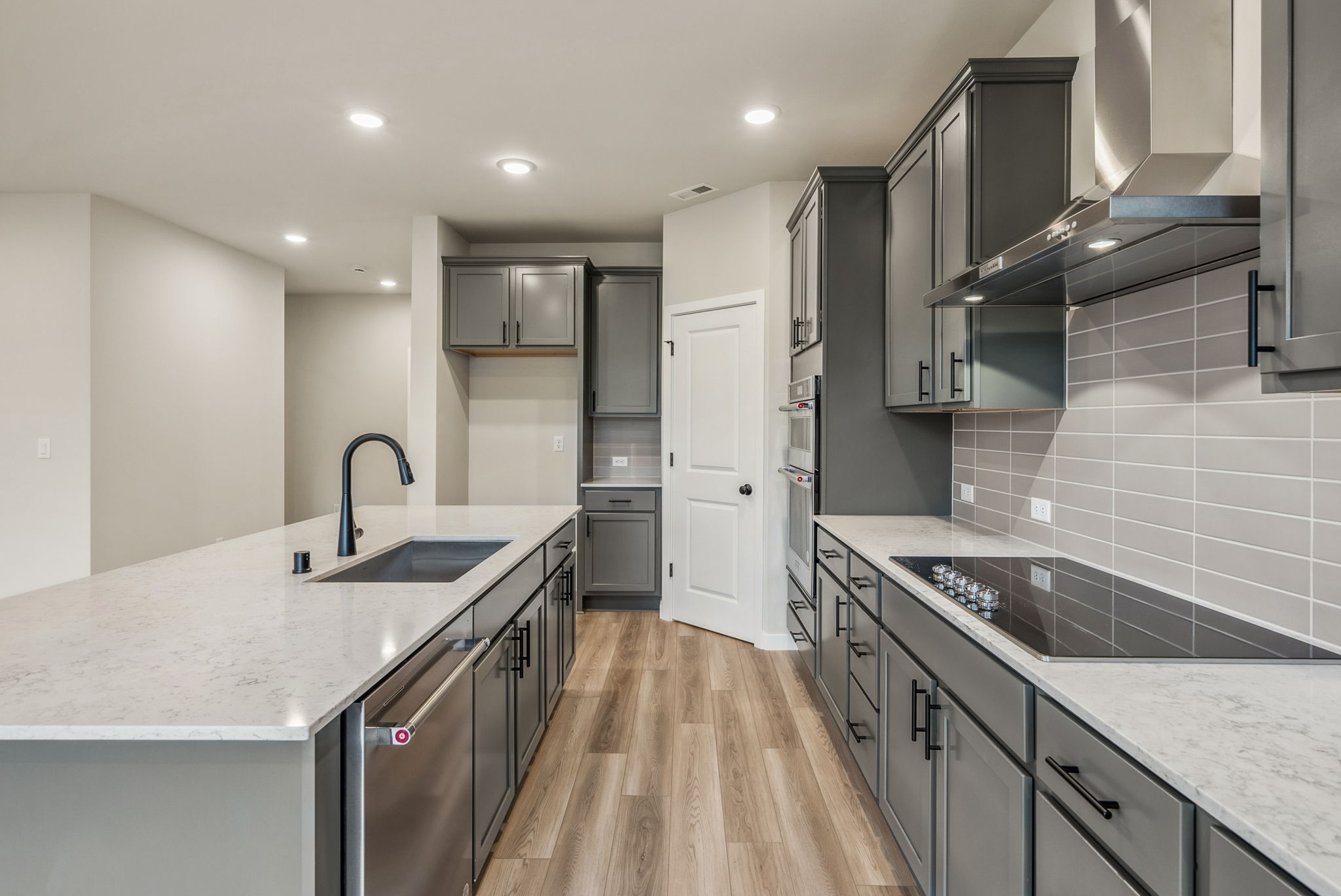 A kitchen with black cabinets.