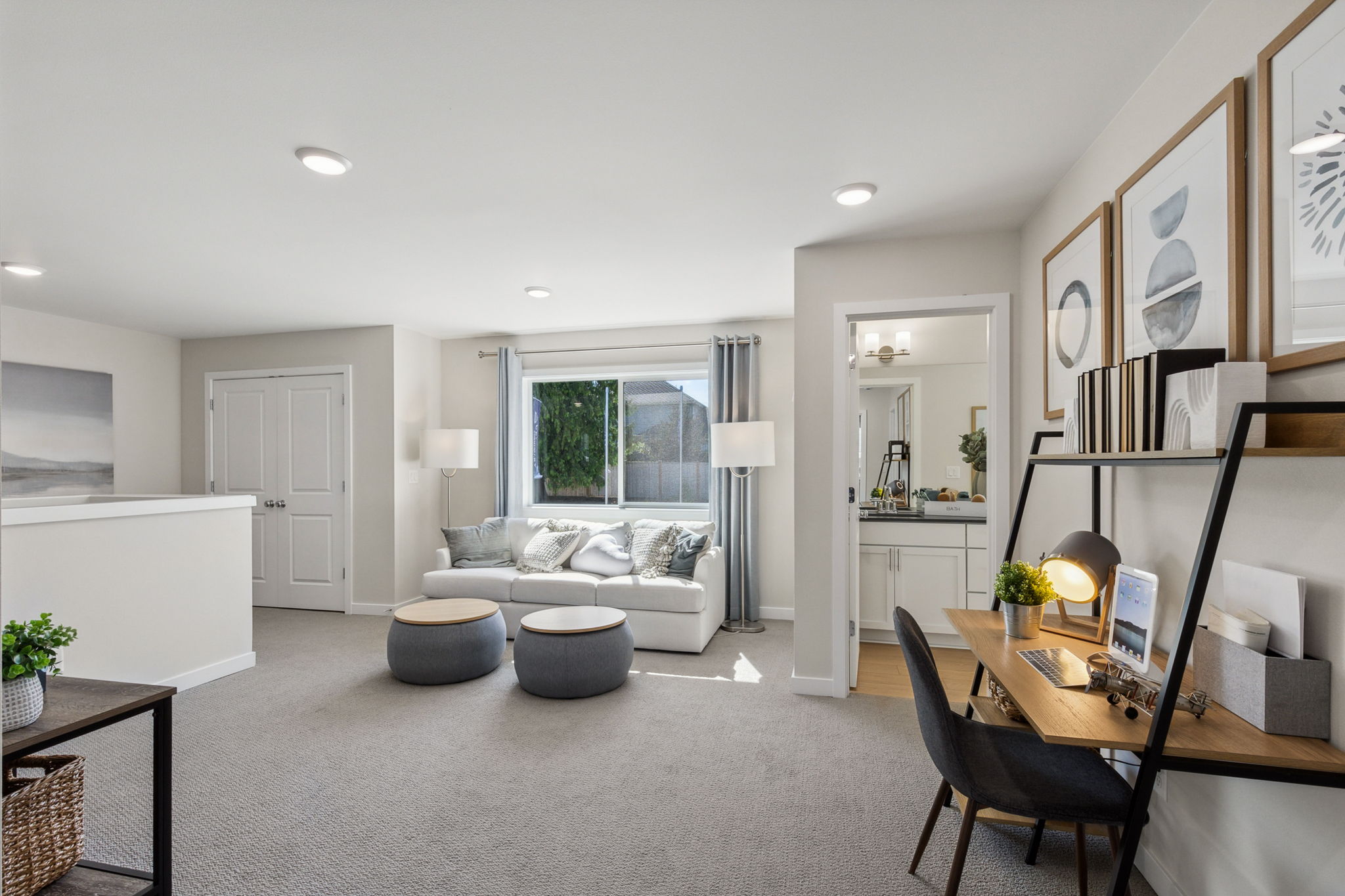 A living room with a couch and a desk.