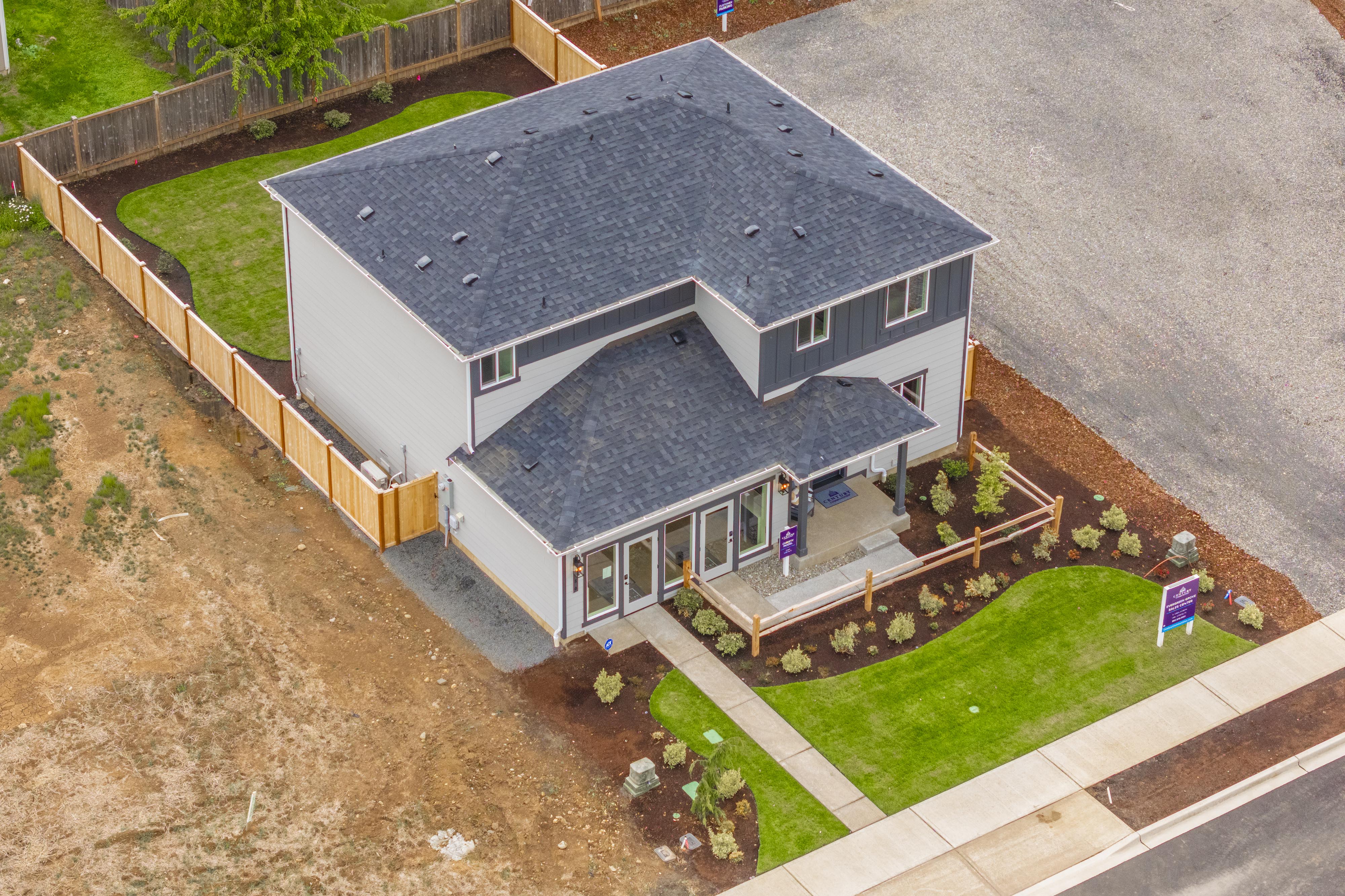 A house with a yard and a fence.