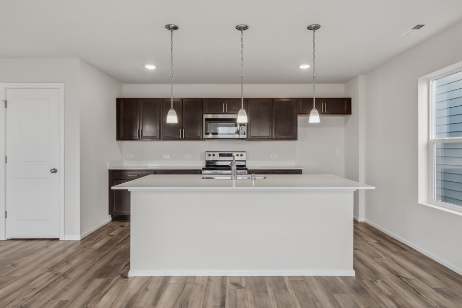 A kitchen with a white counter top.