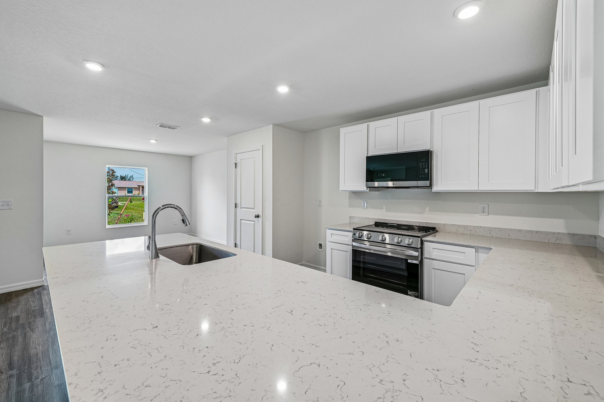 A kitchen with white cabinets.