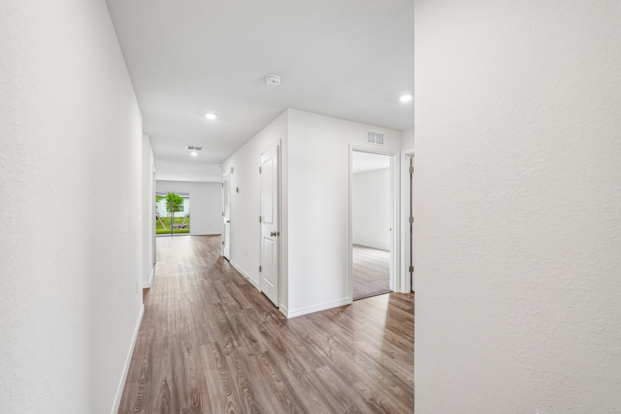 A hallway with white walls.