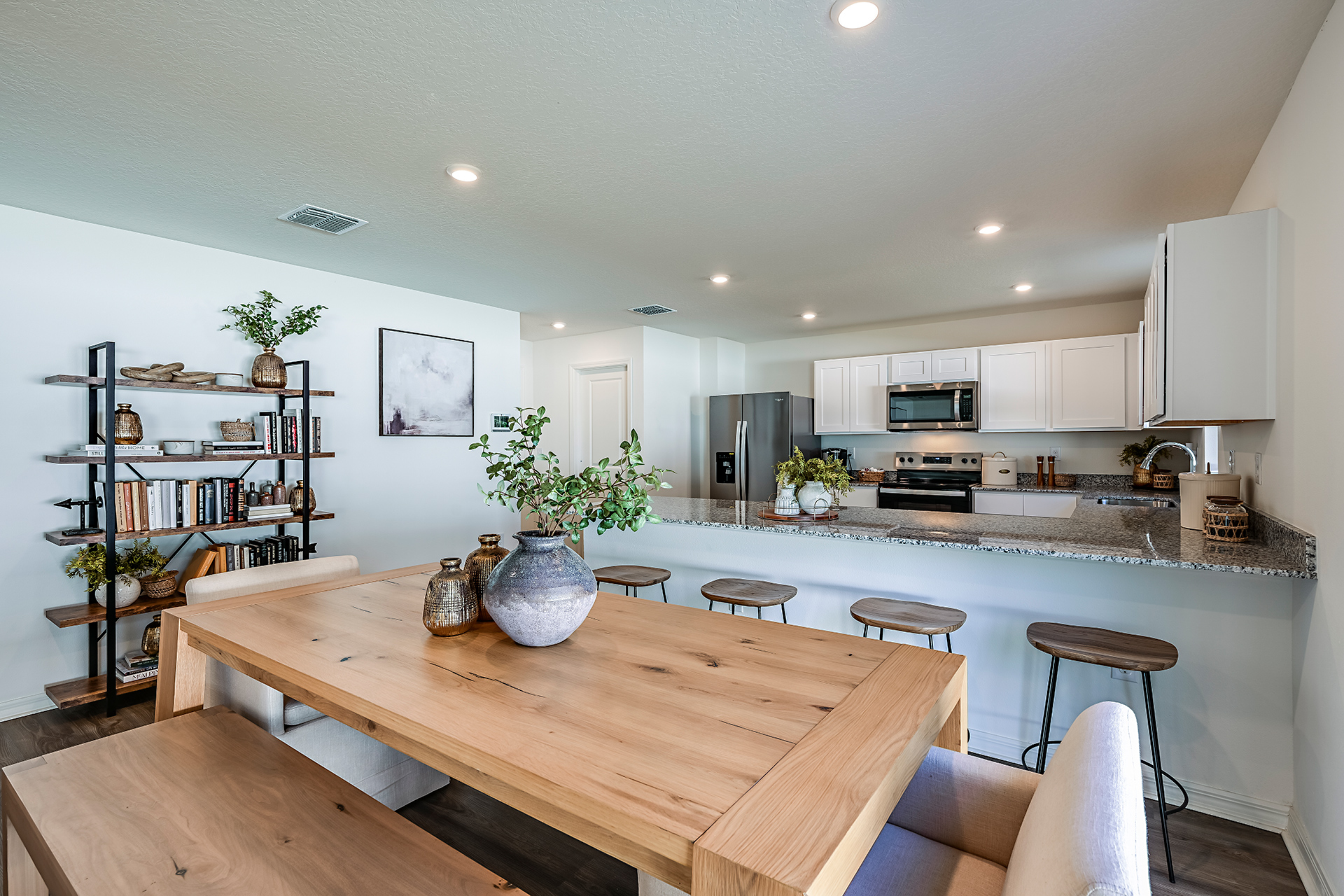 A kitchen with a table and chairs.