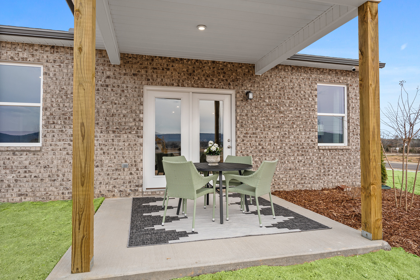 A patio with a table and chairs.