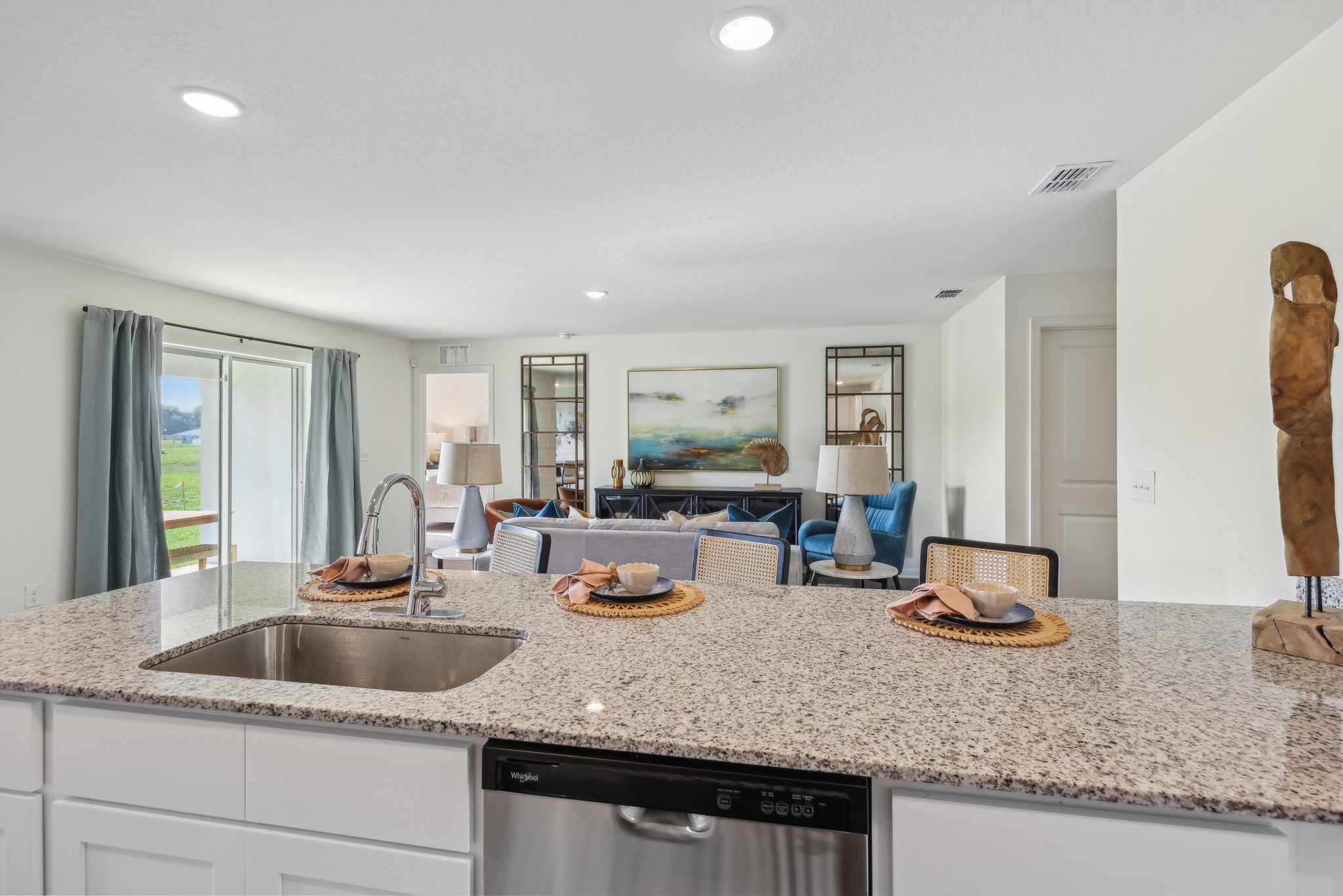 A kitchen with a marble counter top.