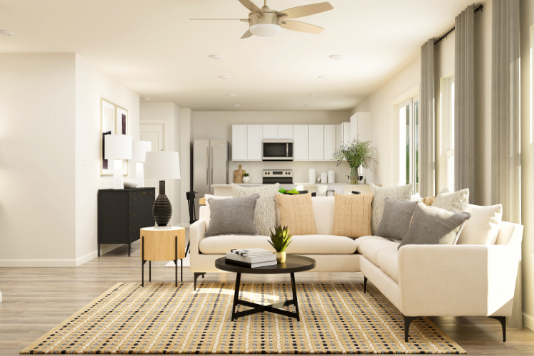 A living room with a white couch and a table.