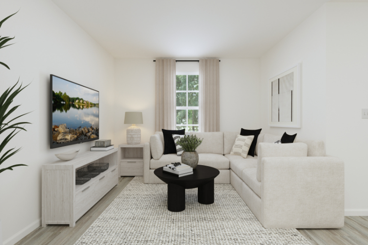A living room with a white couch and a coffee table.