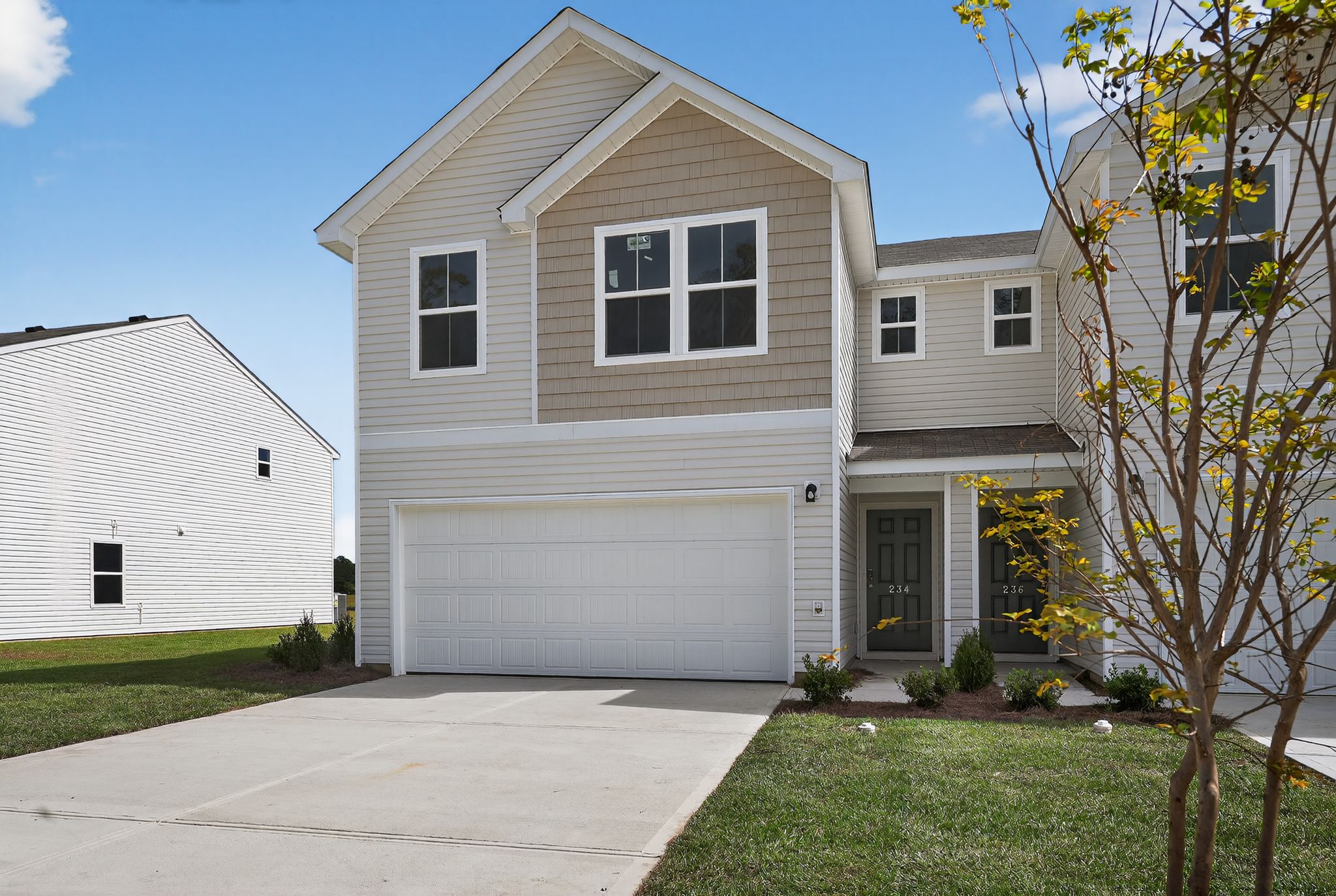 A white house with a garage.