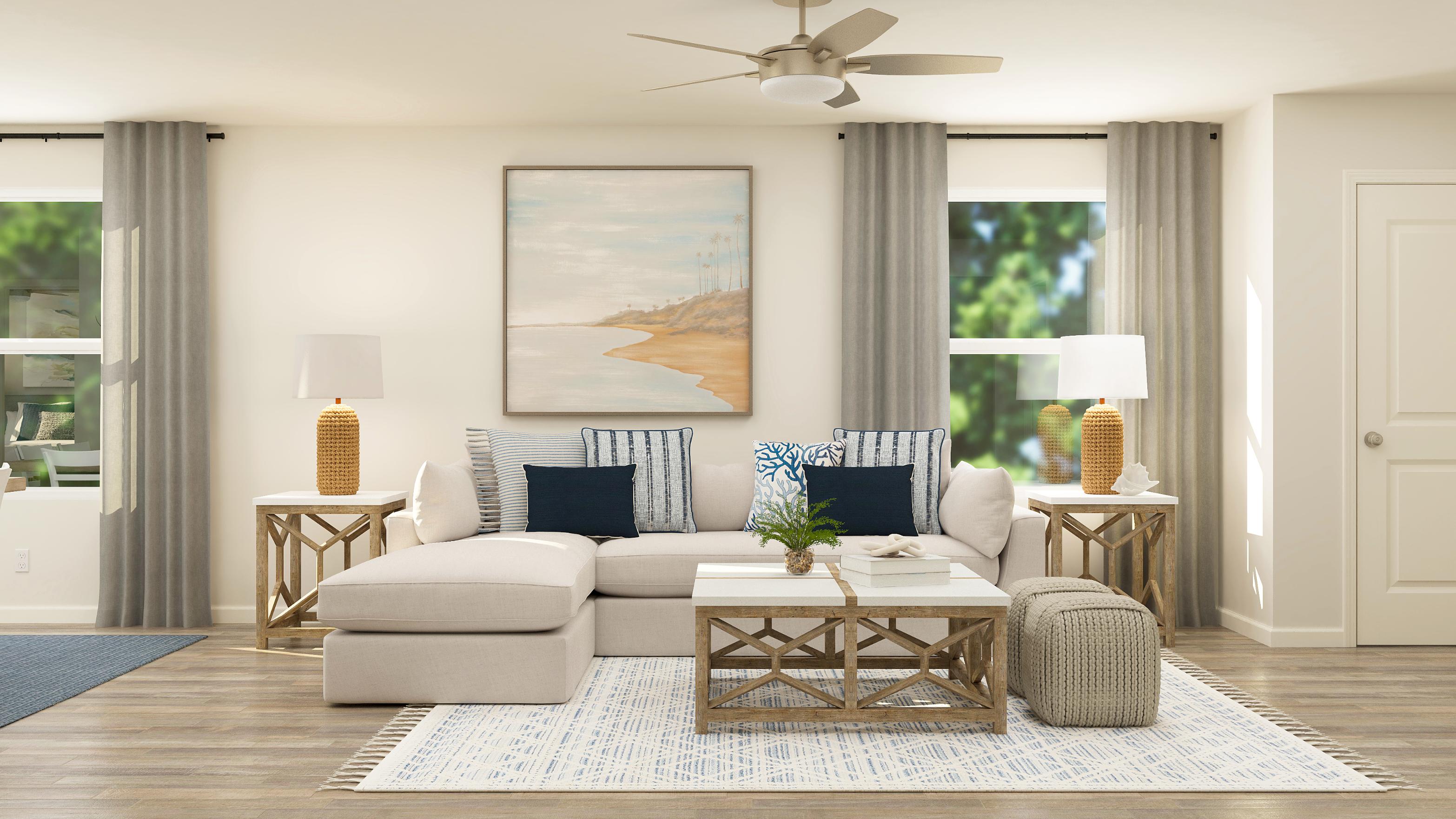 A living room with a couch and a fan.